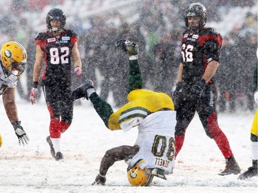 Almond Sewell of the Edmonton Eskimos makes a somersault after sacking Henry Burris of the Ottawa Redblacks during the second half of the CFL's East Division Final the held at TD Place in Ottawa, November 20, 2016.