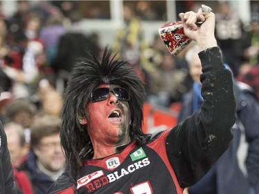 An Ottawa Redblacks fan cheers for his team before the CFL Grey Cup game, Sunday, November 27, 2016 in Toronto.