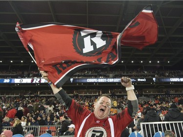 An Ottawa Redblacks fan waves a flag prior to the opening kickoff of the CFL Grey Cup game, Sunday, November 27, 2016 in Toronto.