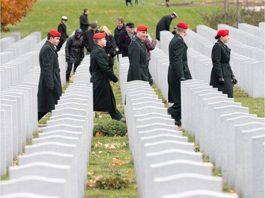 as families, veterans, and military personnel attend Remembrance Day ceremonies at Beechwood Cemetery.