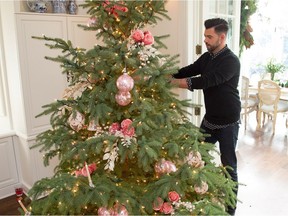 Audy Czigler of Tinseltown Emporium decorates the tree.