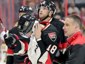 Blood can be seen running down Ryan Dzingel's face as he is taken off the ice by the Sens head athletic therapist, Gerry Townsend, in the first period of Ottawa's matchup against the Boston Bruins Thursday (Nov.4, 2016) at Canadian Tire Centre in Ottawa.