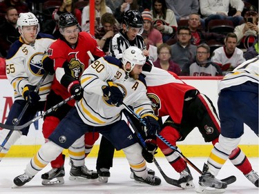Buffalo's Ryan O'Reilly holds off Ottawa's Mike Stone and Kyle Turris in a battle for the puck during third-period action between the Ottawa Senators and the Buffalo Sabres Tuesday (Nov. 29, 2016) at the Canadian Tire Centre in Ottawa. Despite a hat trick from Ottawa's Mike Hoffman, Buffalo still beat the Sens 5-4. Julie Oliver/Postmedia