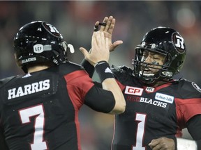 Ottawa Redblacks quarterback Henry Burris (1) celebrates a touchdown with Trevor Harris during third quarter CFL Grey Cup action Sunday, November 27, 2016 in Toronto.