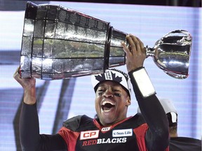 Ottawa Redblacks Henry Burris holds up the Grey Cup celebrating his team's win over the Calgary Stampeders in Toronto on Sunday, November 27, 2016.
