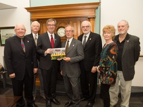 Bytown Antique and Bottle Club members present Mayor Jim Watson with the 2017 Antique Treasures of Ottawa calendar. On hand for the ceremony were Shaun Markey, Jon Church, Mayor Watson, Laurin Garland, Don Hewson, Carol Cameron, and Nick Cameron.