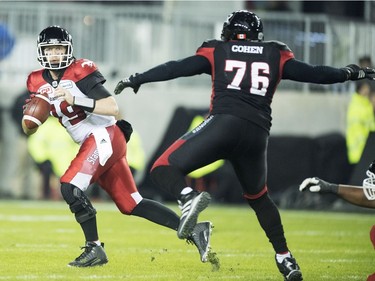 Calgary Stampeders quarterback Bo Levi Mitchell (19) looks to pass as Ottawa Redblacks defensive lineman Landon Cohen (76) defends during second quarter CFL Grey Cup action Sunday, November 27, 2016 in Toronto.