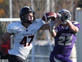 Carleton Ravens defensive back Thomas Knapp breaks up a pass attempt to Western Mustangs running back Myles Rombough during an OUA semifinal playoff football game at TD Stadium in London, Ont., on Saturday November 5, 2016.