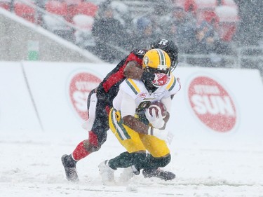 Cauchy Muamba of the Edmonton Eskimos is tackled from behind and has his face mask pulled illegally by Ernest Jackson of the Ottawa Redblacks during first half of the CFL's East Division Final held at TD Place in Ottawa, November 20, 2016.  Photo by Jean Levac  ORG XMIT: 125313