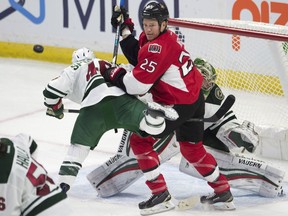 Ottawa Senators right wing Chris Neil (25) keeps his eye on the puck as he battle with Minnesota Wild defenceman Jared Spurgeon (46) in front of goalie Darcy Kuemper (35) during second period NHL action Sunday November 13, 2016 in Ottawa.