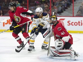 Buffalo Sabres right wing Brian Gionta, centre, tries to tip a shot past Ottawa Senators goalie Craig Anderson as defenceman Cody Ceci looks on during first period NHL action Saturday, Nov. 5, 2016 in Ottawa. It has been less than two weeks since Anderson learned his wife, Nicholle, had been diagnosed with cancer.