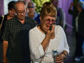 A woman cries as she waits to pay the last respects to Cuban revolutionary icon Fidel Castro, at Jose Marti's Memorial at Revolution Square in Havana, on November 28, 2016.  A titan of the 20th century who beat the odds to endure into the 21st, Castro died late Friday after surviving 11 US administrations and hundreds of assassination attempts. No cause of death was given. Castro's ashes will go on a four-day island-wide procession starting Wednesday before being buried in the southeastern city of Santiago de Cuba on December 4. /