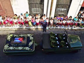 The urn with the ashes of Cuban leader Fidel Castro is driven through Matanzas, Cuba starting a four-day journey across the island, on November 30, 2016.  A military jeep carried the ashes of Fidel Castro along streets lined with hundreds of thousands of flag-waving Cubans in Havana on Wednesday, starting a four-day journey to his final resting place across the island. /