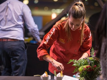 Daniela Manrique of The Soca Kitchen prepares plates of Pig Ear Crusted Tuna as ten Ottawa area chefs compete in the annual Gold Medal Plates competition and fund raiser for the Canadian Olympic Organization.   Wayne Cuddington/ Postmedia