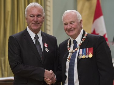 Governor General David Johnston invests Joseph Georges Arsenault, of Charlottetown, P.E.I., as a Member of the Order of Canada during a ceremony at Rideau Hall in Ottawa, Thursday, November 17, 2016.