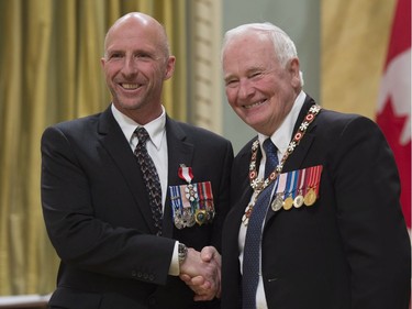 Governor General David Johnston invests Richard Weber, of Alcove, Que., as a Member of the Order of Canada during a ceremony at Rideau Hall in Ottawa, Thursday, November 17, 2016.