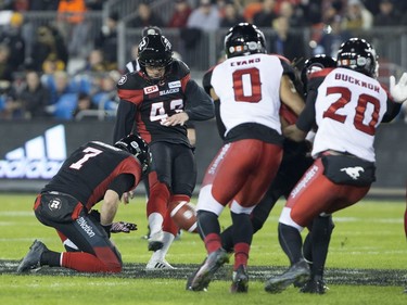 Ottawa Redblacks placekicker Ray Early kicks a field goal while Trevor Harris holds during first quarter CFL Grey Cup action against the Calgary Stampeders, Sunday, November 27, 2016 in Toronto.