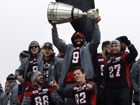 Ottawa Redblacks Ernest Jackson holds the Grey Cup during a parade celebrating the team's victory over the Calgary Stampeders, Tuesday, Nov. 29, 2016 in Ottawa.