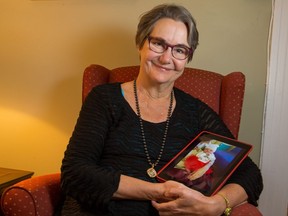 Former Carleton University journalism professor Catherine McKercher, holding a photo of her grand daughter Noelle, is photographed at her home. She writes an op-ed about why her grand child isn't considered a Canadian citizen under our byzantine citizenship laws and how outrageous that is.   Wayne Cuddington/ Postmedia