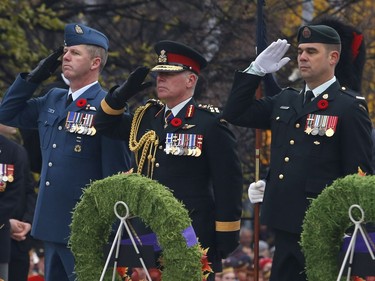 General Jonathan Vance, Chief of the Defence Staff, centre, salutes during Remembrance Day ceremonies at the War Memorial in Ottawa on Friday, November 11, 2016.