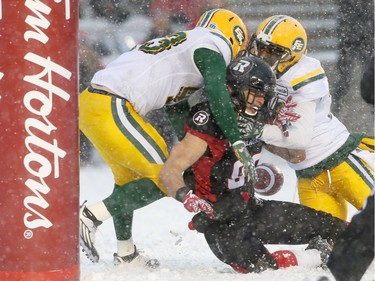 Greg Ellingson (82) of the Ottawa Redblacks couldn't make the catch in the end zone as he is tackled by Neil King (L) and Brandyn Thompson of the Edmonton Eskimos during the second half of the CFL's East Division Final the held at TD Place in Ottawa, November 20, 2016.