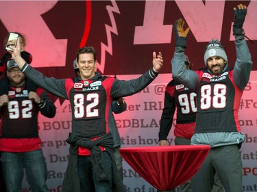 Greg Ellingson (L) and Brad Sinopoli are introduced to the crowd as the Ottawa Redblacks celebrate their Grey Cup victory with a parade down Bank St and a celebration at Lansdowne Park.