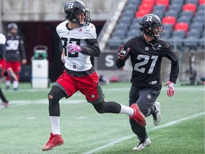 Greg Ellingson (L) and Mitchell White look for a pass as the Ottawa Redblacks practice at TD Place with the team preparing to face the Edmonton Eskimos in the CFL Eastern Final on Sunday.