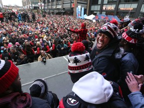 RedBlacks quarterback and Grey Cup MVP Henry Burris talks to the crowd during the celebration rally Tuesday.
