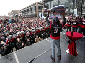 Thousands of RedBlacks fans attended a rally at Lansdowne park after  the 2016 Grey Cup Parade in Ottawa Tuesday Nov 29, 2016. RedBlacks Ernest Jackson lifts the Grey Cup during the rally Tuesday.