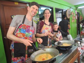 Griff Mercer (L), Audrey Letouzé and their nine-year-old son Eric at a Bangkok cooking school in 2015.