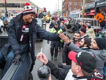 Henry Burris greets fans along Bank St as the Ottawa Redblacks celebrate their Grey Cup victory with a parade down Bank St and a celebration at Lansdowne Park.