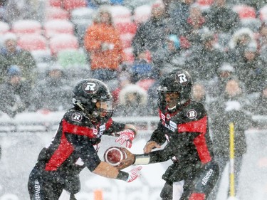 Henry Burris (R) of the Ottawa Redblacks does the hand off to Kienan Lafrance  against the Edmonton Eskimos during first half of the CFL's East Division Final held at TD Place in Ottawa, November 20, 2016.  Photo by Jean Levac  ORG XMIT: 125313