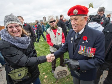 Jack Commerford shakes hands from well wishers after taking part in Remembrance Day ceremonies at Beechwood Cemetery. Jack served with the artillery in WW2 and then switched to the RCR and trained men going to Korea.