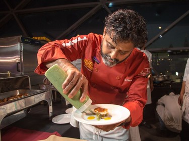 Joe Thottungal of Coconut Lagoon prepares plates of Poached Halibut as ten Ottawa area chefs compete in the annual Gold Medal Plates competition and fund raiser for the Canadian Olympic Organization.