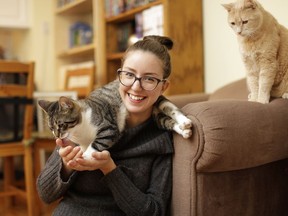 Josée Cyr hangs out with two of her three cats, Tut and Bella, in her home on Nov. 10, 2016. Cyr is launching Ottawa's first cat cafe, set to open this spring.