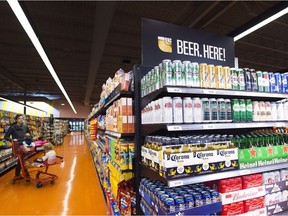 Beer is shown on newly stocked shelves as customers shop at a Loblaws grocery store in Toronto on Tuesday, December 15, 2015.