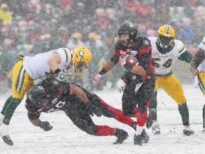Kienan Lafrance (27) of the Ottawa Redblacks misses the tackle by JC Sherritt of the Edmonton Eskimos during first half of the CFL's East Division Final held at TD Place in Ottawa, November 20, 2016.