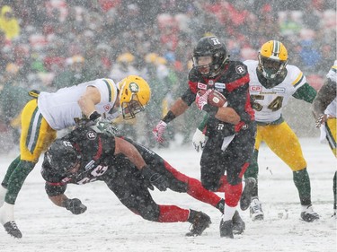 Kienan Lafrance (27) of the Ottawa Redblacks misses the tackle by JC Sherritt of the Edmonton Eskimos during first half of the CFL's East Division Final held at TD Place in Ottawa, November 20, 2016.