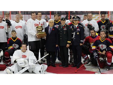 Korean Ambassador Daeshik Jo, centre, dressed in a suit, attended the Imjin Hockey Classic, which commemorates games played on the frozen Imjin River by Canadian soldiers. The game, held at the Canadian Tire Centre Nov. 5, saw two regiments, PPCLI and R22eR, go head-to-head just as they did during the Korean War.