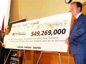 Laurentian University President and Vice-Chancellor Dominic Giroux looks on as Paul Lefebvre, Member of Parliament for Sudbury, and Marc SerrŽ, Member of Parliament for Nickel Belt on behalf of the Honourable Kirsty Duncan, Minister of Science,unveil a cheque $49,269,000 in funding for the Metal Earth project initiative at Laurentian University  in Sudbury, Ont. on Tuesday September 6, 2016. Gino Donato/Sudbury Star/Postmedia Network