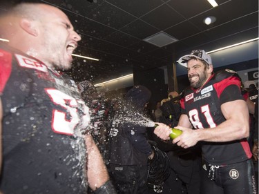 Ottawa Redblacks running back Patrick Lavoie (81) sprays a teammate as he celebrates his team's Grey Cup win over the Calgary Stampeders in Toronto on Sunday, November 27, 2016.