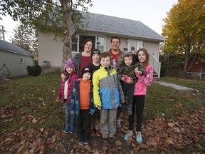 Melissa Greenlaw and fiancé Christopher Davidson pose for a photo with their family, left to right, Cassidy, 7, Logan, 6, Nicholas 11, Dominic, 9,  Landon, 2, Kaylea, 12. Two children were absent for the photo.