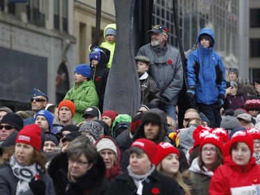 Members of the public watch the Remembrance Day ceremonies at the War Memorial in Ottawa on Friday, November 11, 2016.