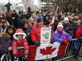 Members of the public watch the Remembrance Day ceremonies at the War Memorial in Ottawa on Friday, November 11, 2016.