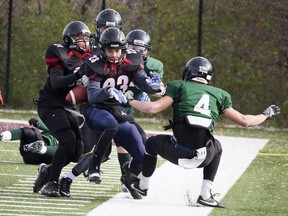 The ball comes loose during the A/AA championship game between Franco-Cité (in green) and St. Mark on Saturday, Nov. 12, 2016 at the University of Ottawa Gee-Gees Field.  Franco Cité won the title with a 7-4 victory.