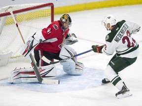 Ottawa Senators goalie Craig Anderson blocks a shot from Minnesota Wild right wing Nino Niederreiter (22) during second period NHL action Sunday November 13, 2016 in Ottawa.