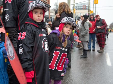 Noah (7) and Kiera (6) Gaughn wait anxiously for the parade as the Ottawa Redblacks celebrate their Grey Cup victory with a parade down Bank St and a celebration at Lansdowne Park.