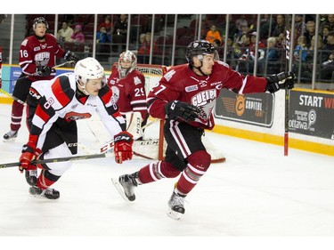 The 67's Ben Fanjoy tries to catch the Storm's Garrett McFadden as he goes after a loose puck.