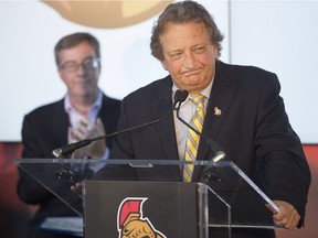 Ottawa mayor, Jim Watson, left, looks on as Ottawa Senators' owner, Eugen Melnyk, speaks during a press conference to announce a major community fundraising milestone for the Ottawa Senators Foundation at Canadian Tire Centre Tuesday, August 19, 2014.