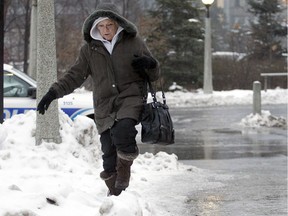 During freezing rain in Ottawa a few years ago, a woman chooses the snowbank over the icy sidewalks along the Queen Elizabeth Parkway downtown.